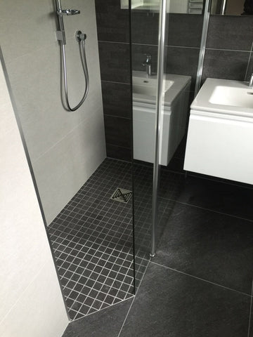 Compact wet room design with modern fixtures and tiled flooring.