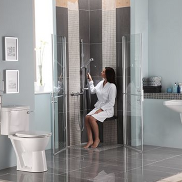 Accessible wetroom with shower seat for wheelchair users.