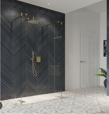 Modern wet room with dark herringbone tiles and gold fixtures.