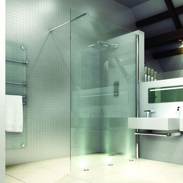 Modern wet room with glass shower screen and sleek fixtures.