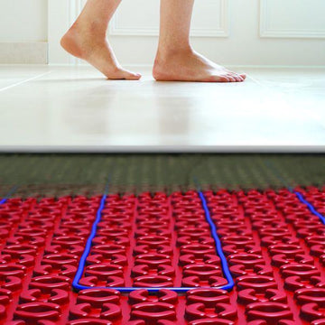Underfloor heating system with red panels and blue piping.