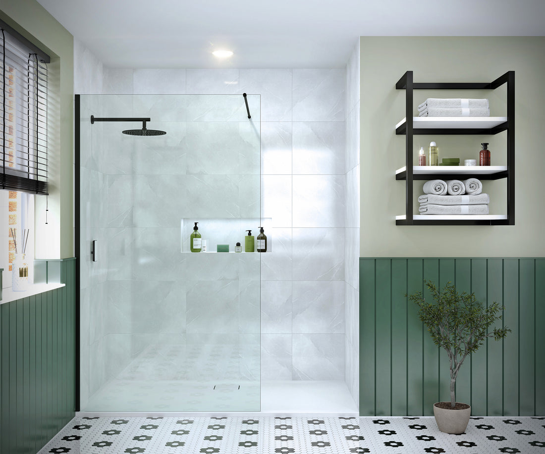 Merlyn 8mm wetroom panel shower screen in a modern bathroom with green paneling and white tiles. Features a black frame and rainfall showerhead.