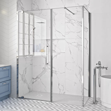 Merlyn Series 10 Pivot Shower Door with Inline and Side Panel in chrome finish, installed in a modern wet room with marble walls and chevron flooring.