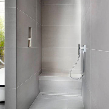 wedi Sanoasa Bench Wet Room Shower Seat - Angled installed in a sleek grey tiled shower, ideal for mobility and accessibility needs.