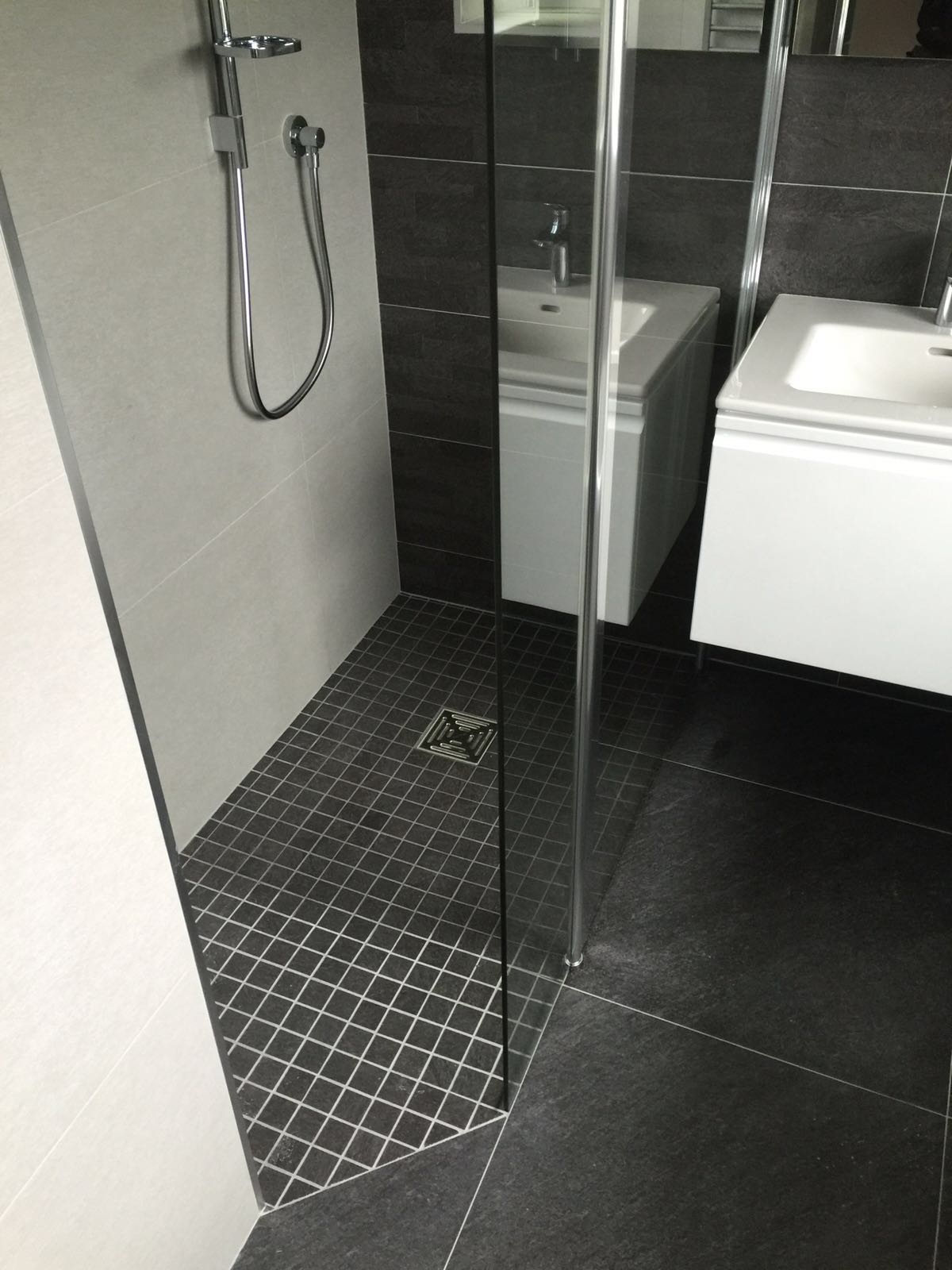 Compact wet room design with modern fixtures and tiled flooring.