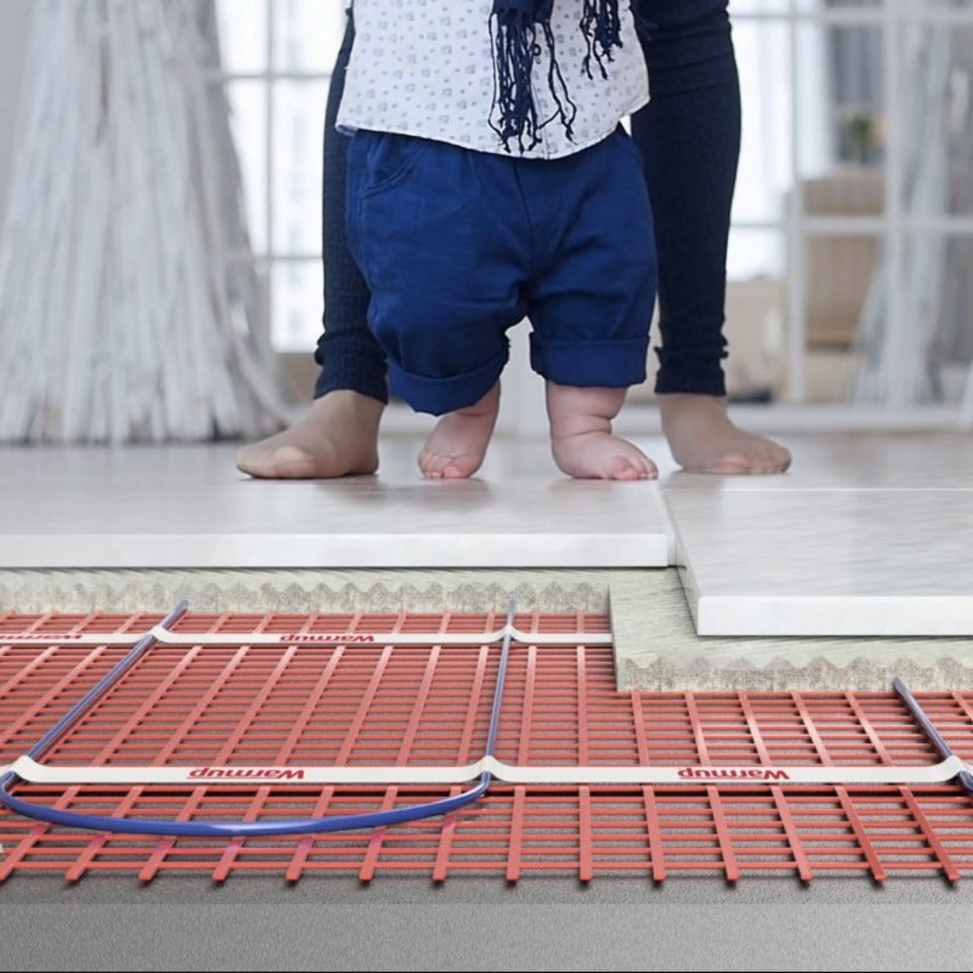 Warmup underfloor heating installation with child walking on tiles.