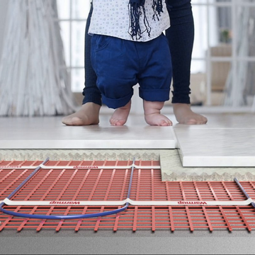 Warmup underfloor heating installation with child walking on tiles.