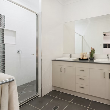 Modern wet room with sleek shower and dual sinks.