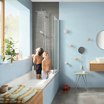 Children enjoying a rain shower head in a modern bathroom.