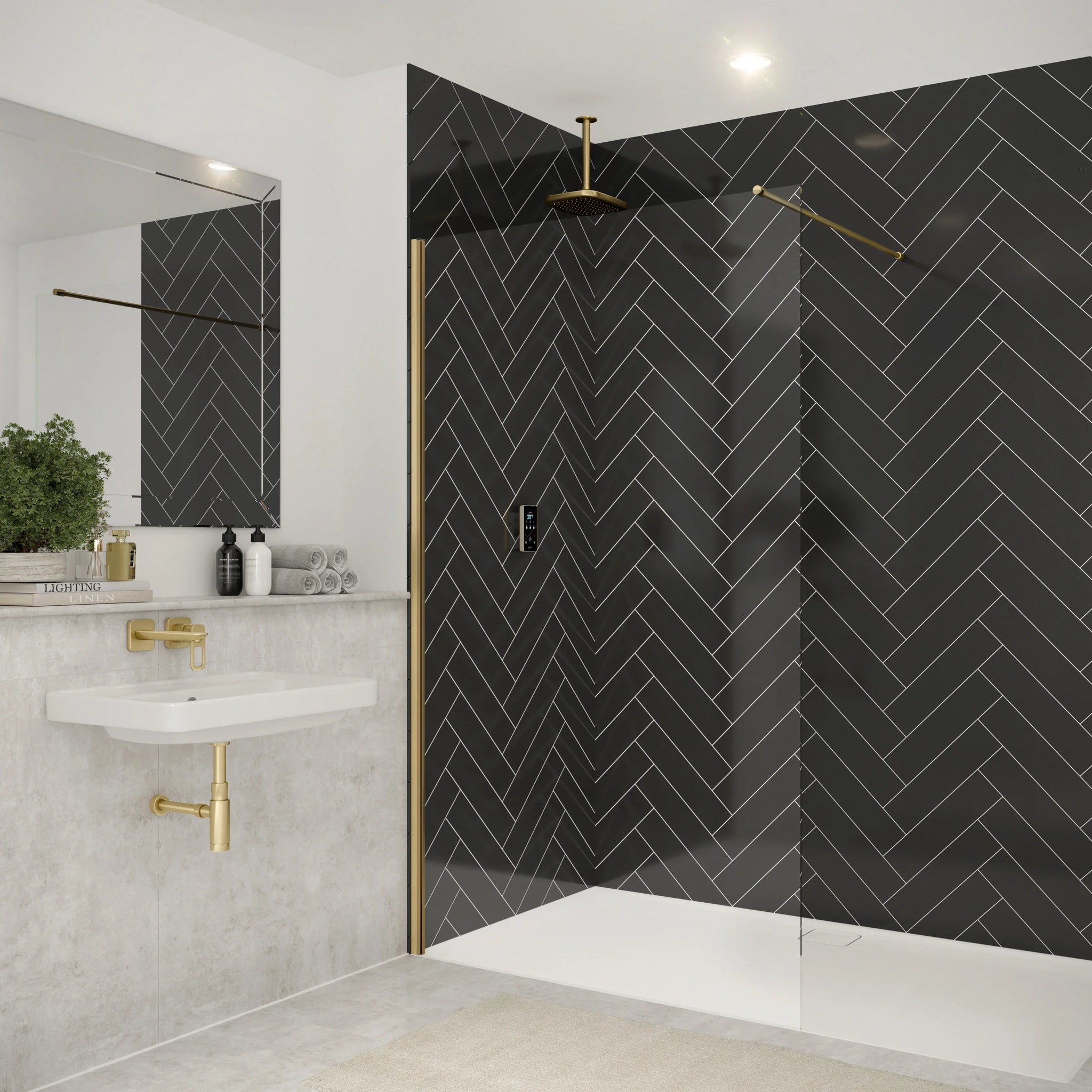Modern bathroom with brushed brass shower screen and black herringbone tiles.