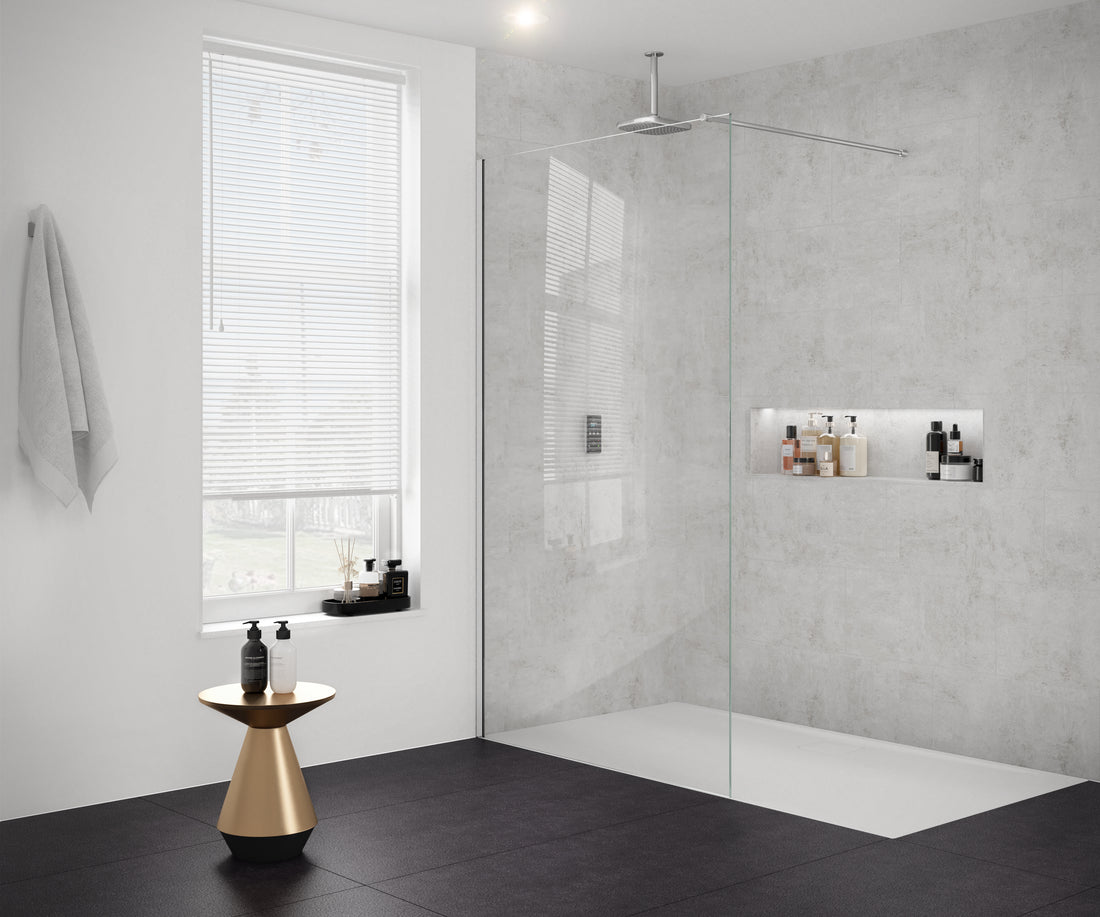 Merlyn 8mm wetroom panel shower screen in a modern bathroom with green paneling and white tiles. Features a black frame and rainfall showerhead.