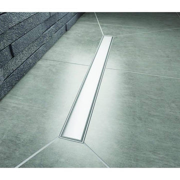 Installed Impey Aqua Dec Linear 4 wet room tray with a brushed stainless steel linear drain cover, seamlessly integrated into a tiled wet room floor.
