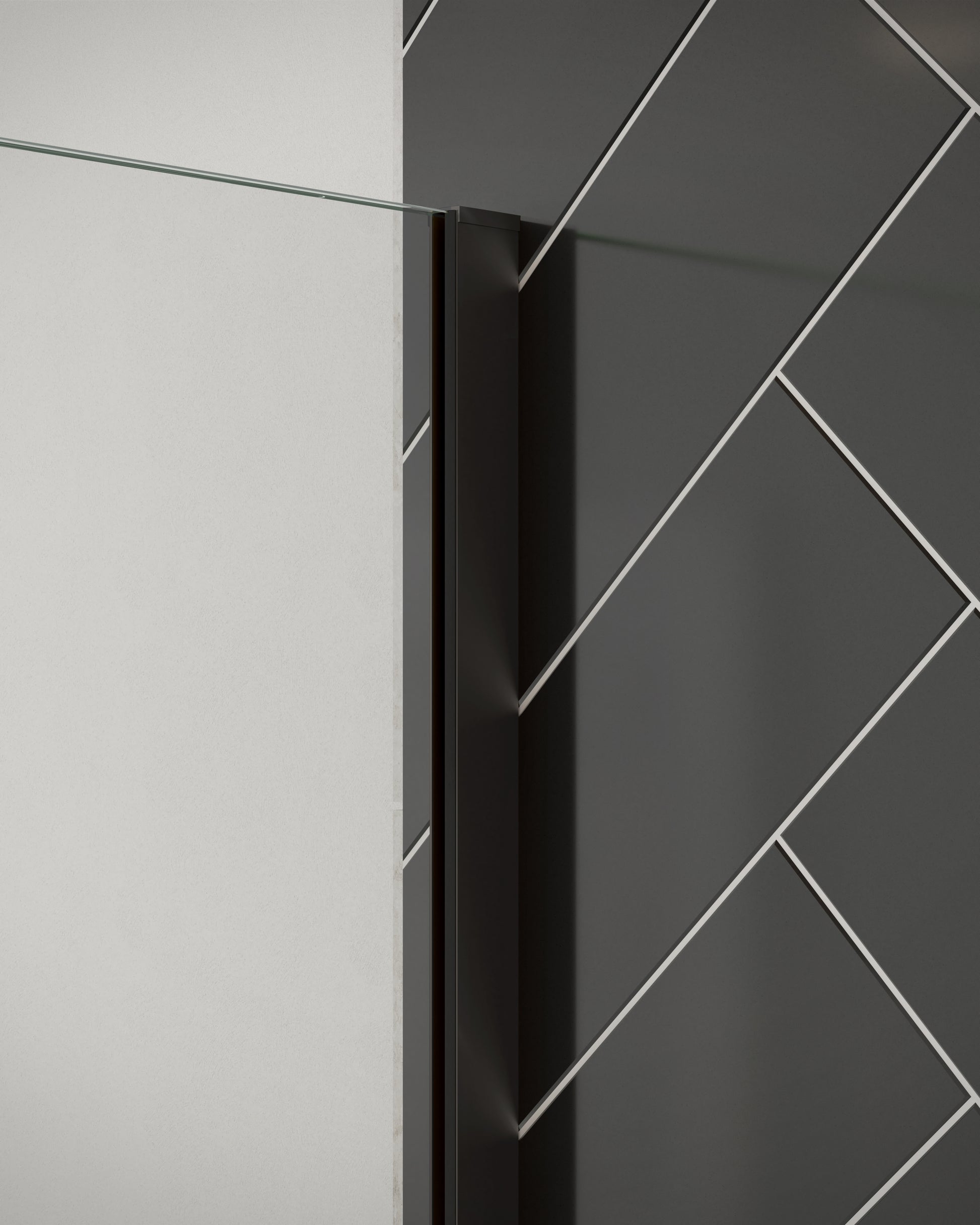 Close-up of Merlyn 8mm wetroom panel shower screen with matt black wall profile. Installed against black herringbone tiles.