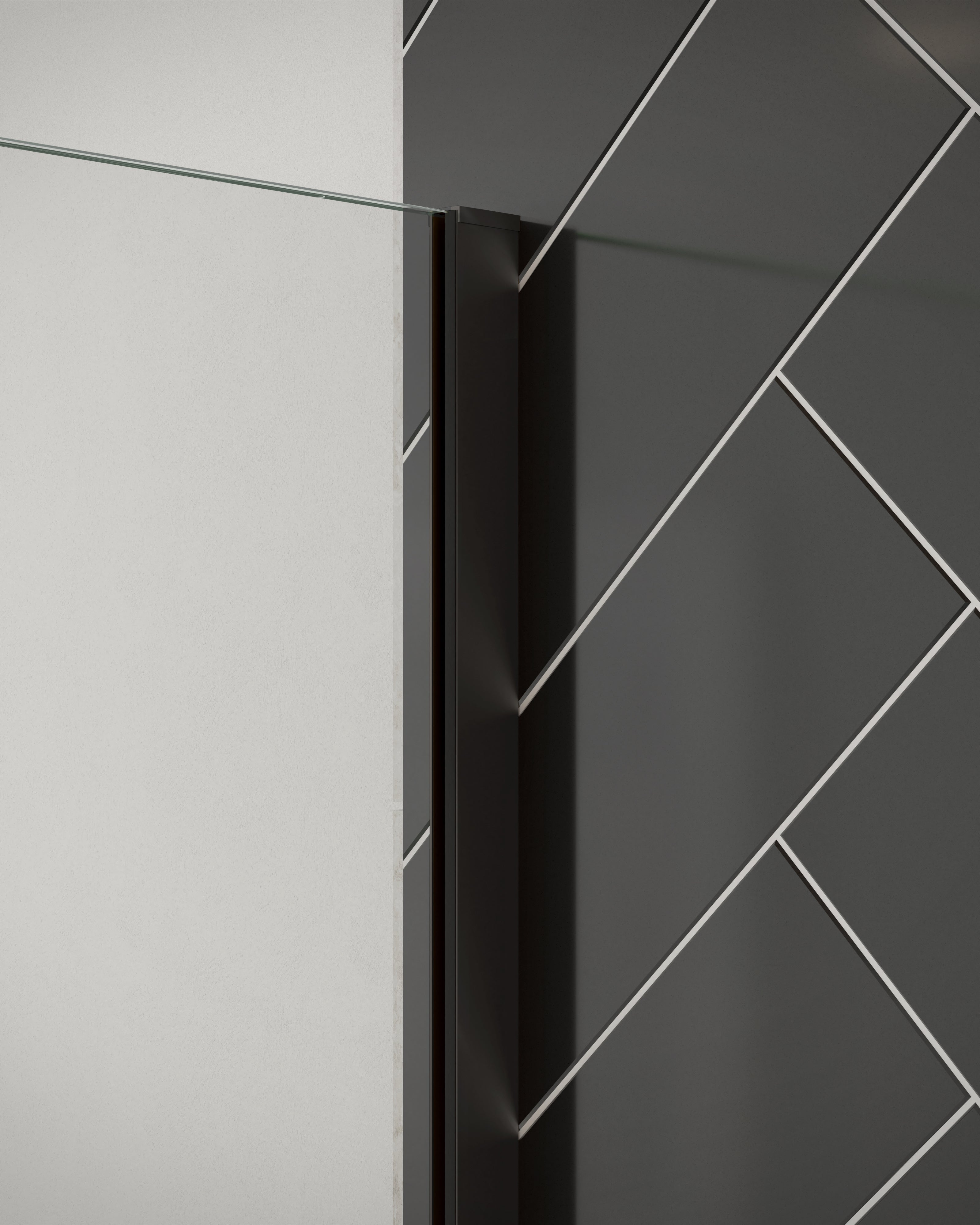 Close-up of Merlyn 8mm wetroom panel shower screen with matt black wall profile. Installed against black herringbone tiles.
