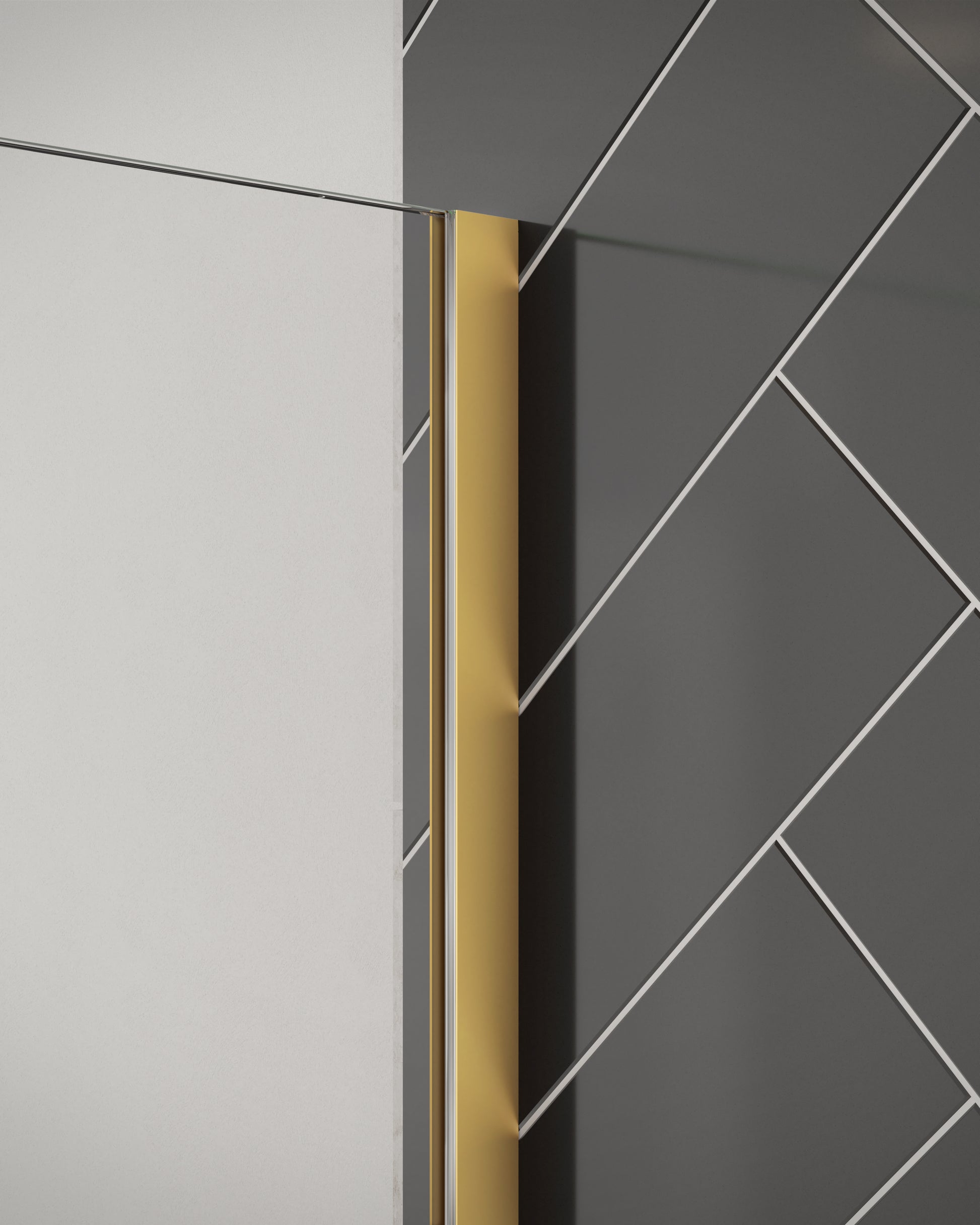 Close-up of Merlyn 8mm wetroom panel shower screen with brushed brass wall profile. Installed against black herringbone tiles.