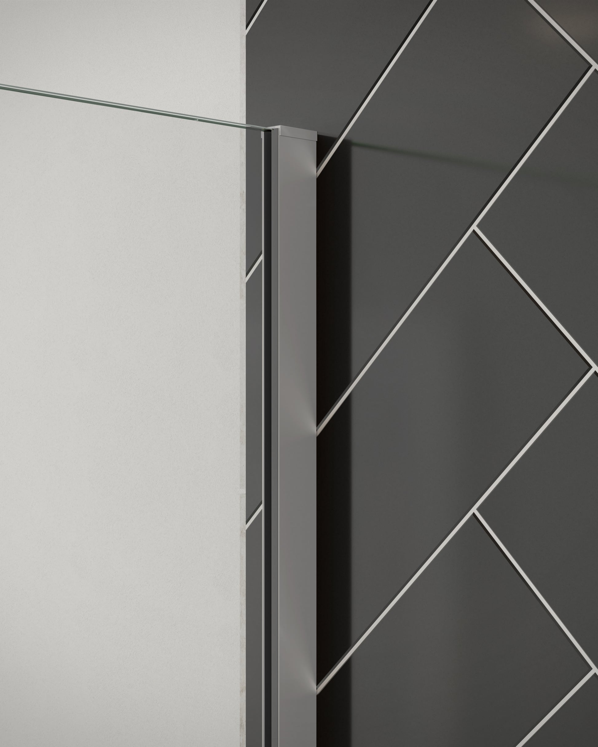 Close-up of Merlyn 8mm wetroom panel shower screen with standard chrome wall profile. Installed against black herringbone tiles.