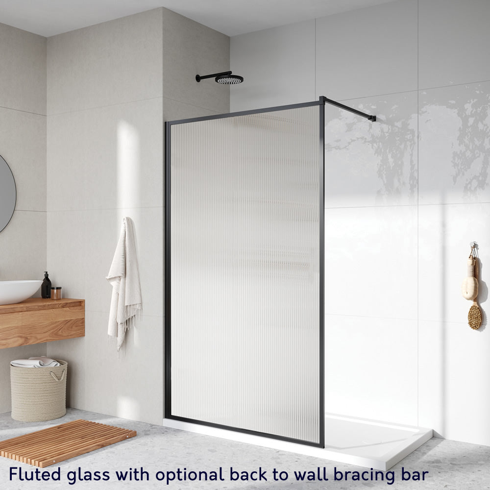 Roman Innov8 Framed Wet Room Shower Screen Panel with fluted glass and a matte black frame, featuring an optional back-to-wall bracing bar. Size: 700mm, 8mm thick glass.