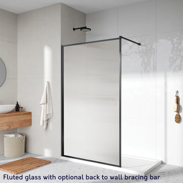 Roman Innov8 Framed Wet Room Shower Screen Panel with fluted glass and a matte black frame, featuring an optional back-to-wall bracing bar. Size: 1000mm, 8mm thick.