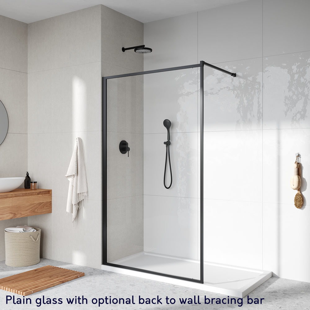 Roman Innov8 Framed Wet Room Shower Screen Panel with plain glass and a matt black frame, featuring an optional back-to-wall bracing bar. Size: 1200mm.