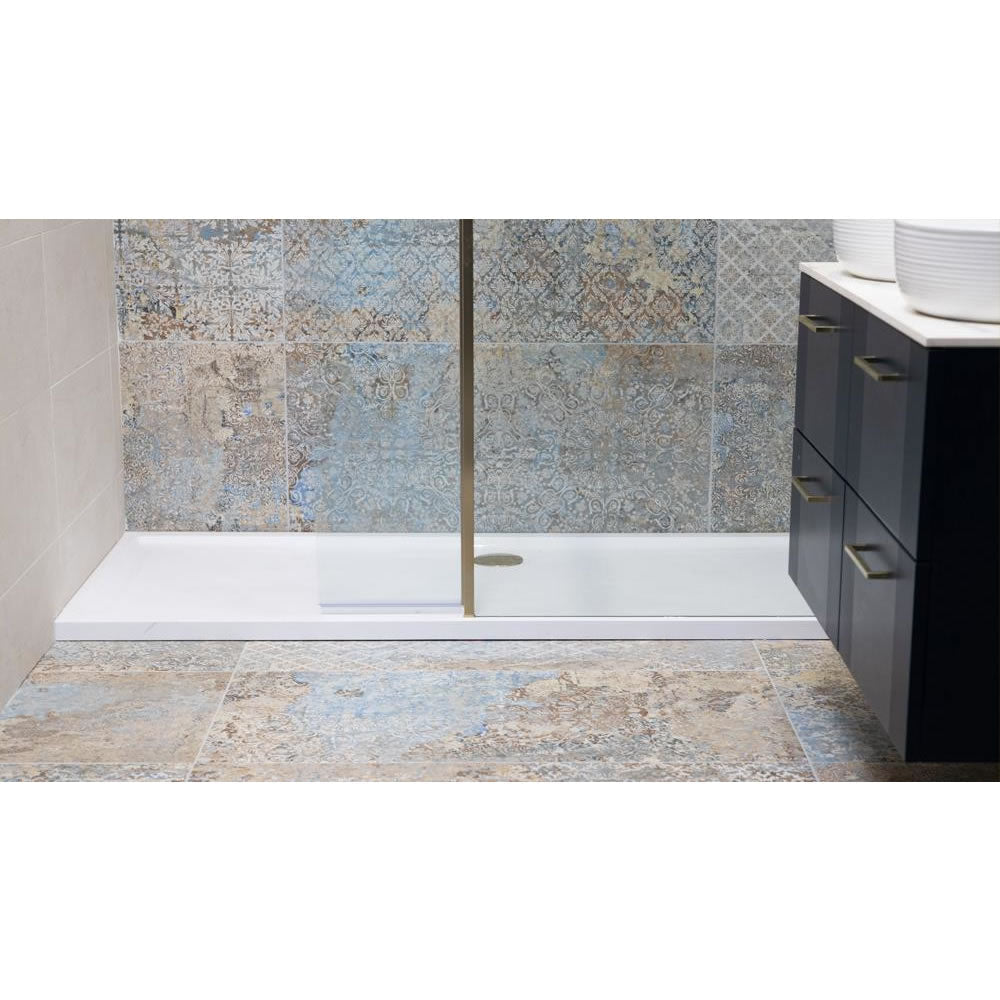 Installed Roman Stone Solid Surface Anti Slip Shower Tray in a modern bathroom with tiled flooring, seamlessly integrated with a wetroom panel.
