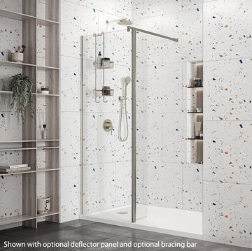 Roman Haven Wetroom Shower Screen Panel 1100mm in polished chrome finish, installed in a modern bathroom with terrazzo tiles. Shown with optional deflector panel and bracing bar.