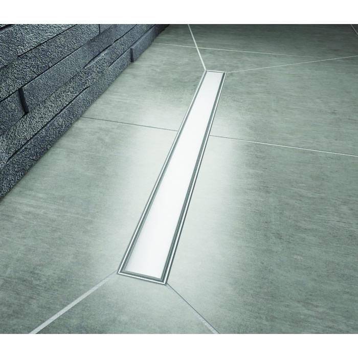 Impey Aqua Dec Linear drain channel with standard brushed stainless steel cover installed on a tiled wet room floor