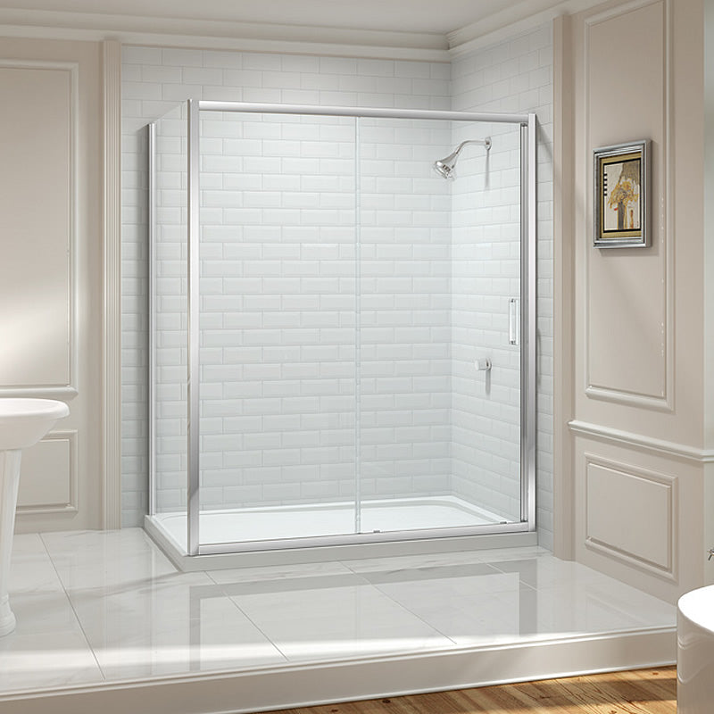 Merlyn 8 Series Sliding Shower Door with Side Panel in chrome finish, installed in a modern wet room with white subway tiles and minimalist decor.